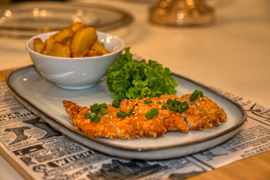 Delicious breaded schnitzel with seasoned potatoes and fresh lettuce, perfect for lunch or dinner.