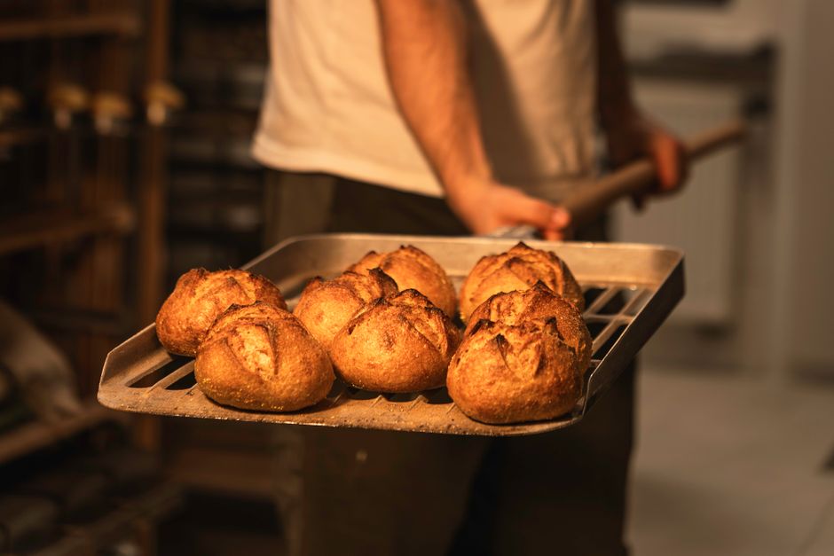 Close-up of freshly baked artisan bread in a bakery, exuding warmth and craftsmanship.